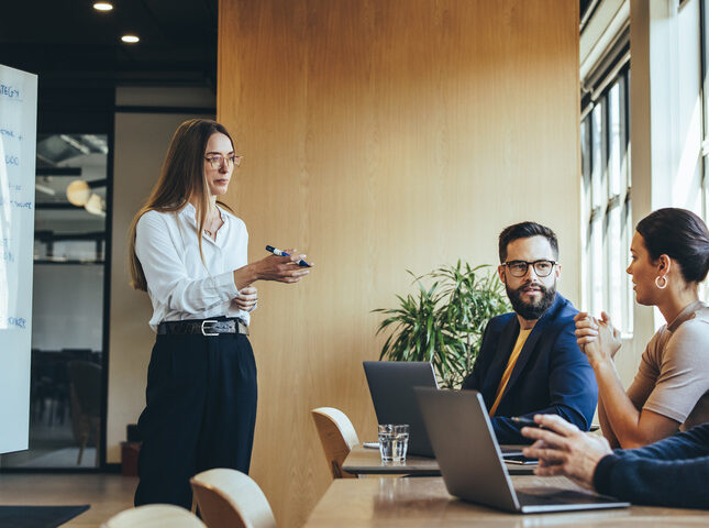 A marketing professional in meeting with law clients discussing marketing strategy